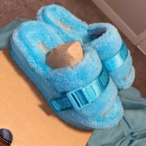 Gently worn fluffy UGG /platform slippers . Size 6 . Baby blue color .